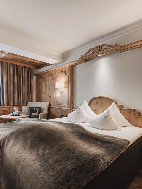 Pictures from Sportalm Cozy hotel room with wood paneling and large bed