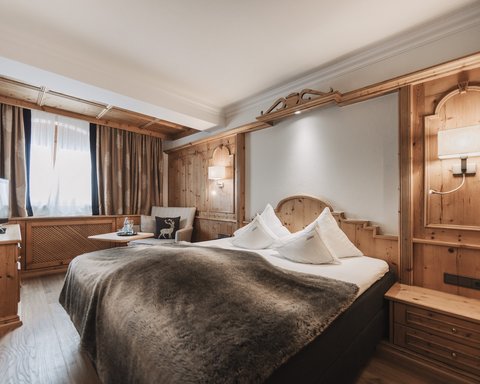 Pictures from Sportalm Cozy hotel room with wood paneling and large bed
