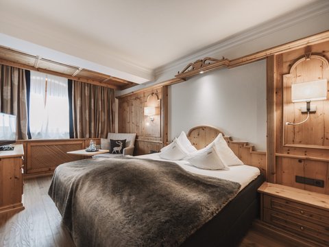 Pictures from Sportalm Cozy hotel room with wood paneling and large bed