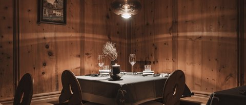 Pictures from Sportalm Cozy table with candle and glasses in rustic wooden room