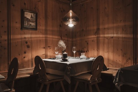 Pictures from Sportalm Cozy table with candle and glasses in rustic wooden room