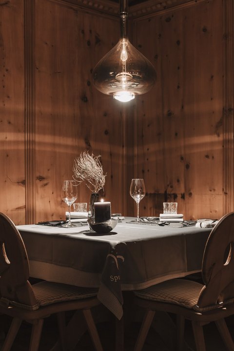 Pictures from Sportalm Cozy table with candle and glasses in rustic wooden room