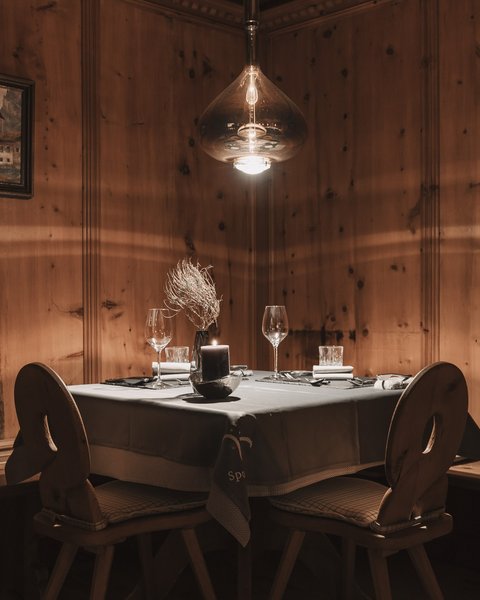 Pictures from Sportalm Cozy table with candle and glasses in rustic wooden room