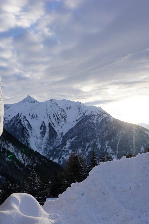 Pictures from Sportalm Snow-covered cabin and mountains at sunset