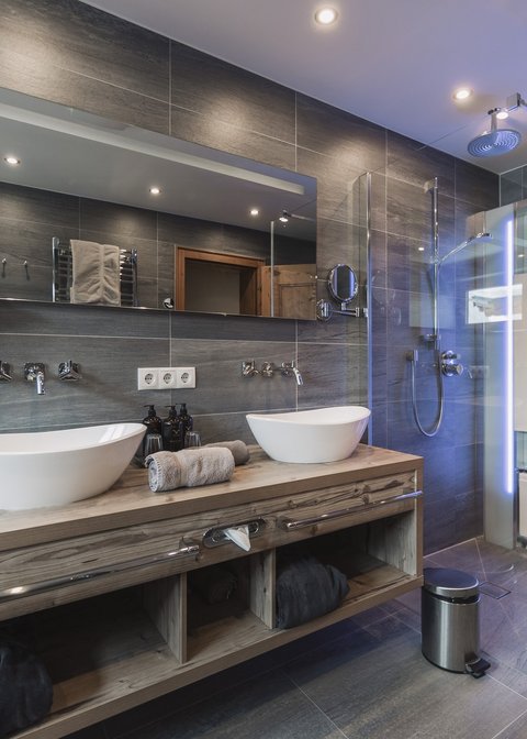 Pictures from Sportalm Modern bathroom with double sink, large mirror, and glass shower enclosure