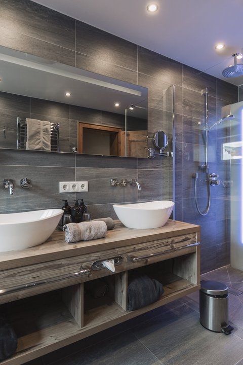 Pictures from Sportalm Modern bathroom with double sink, large mirror, and glass shower enclosure