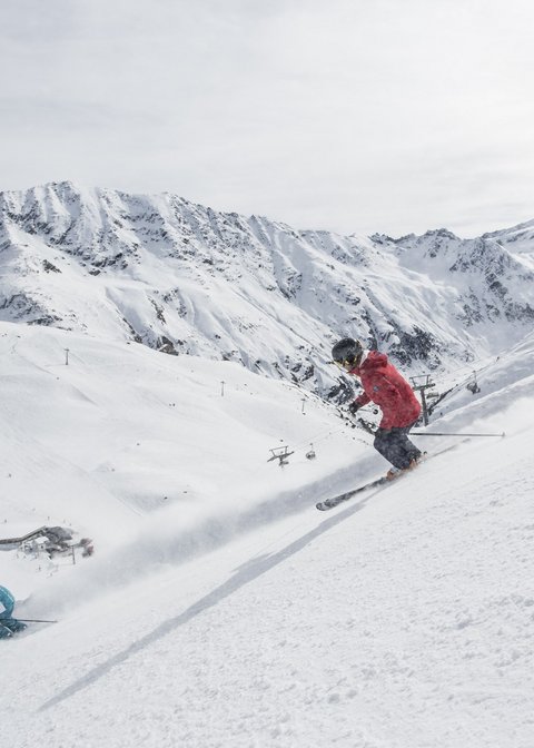 Alpine Resort Sportalm: It’s not just any Pitztal resort! Two skiers skiing down a snowy slope in the mountains