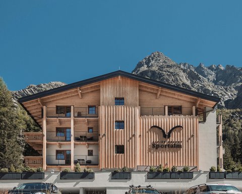 Pictures from Sportalm Alpine resort Sportalm with mountains in the background and parked cars