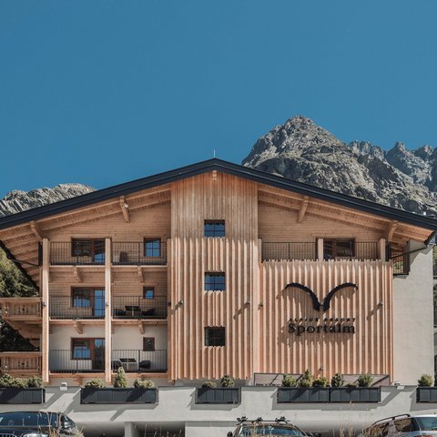 Pictures from Sportalm Alpine resort Sportalm with mountains in the background and parked cars