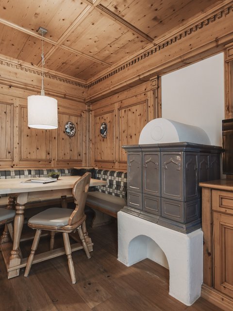 Pictures from Sportalm Cozy wooden room with corner bench, stove, and television