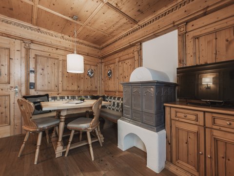 Pictures from Sportalm Cozy wooden room with corner bench, stove, and television