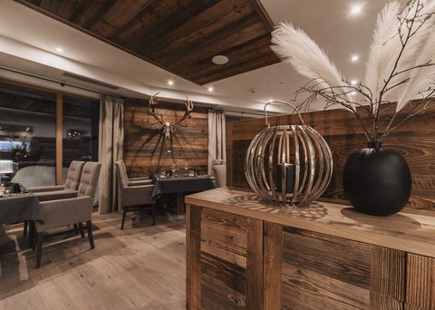 Pictures from Sportalm Rustic restaurant with wooden furniture and deer antlers on the wall