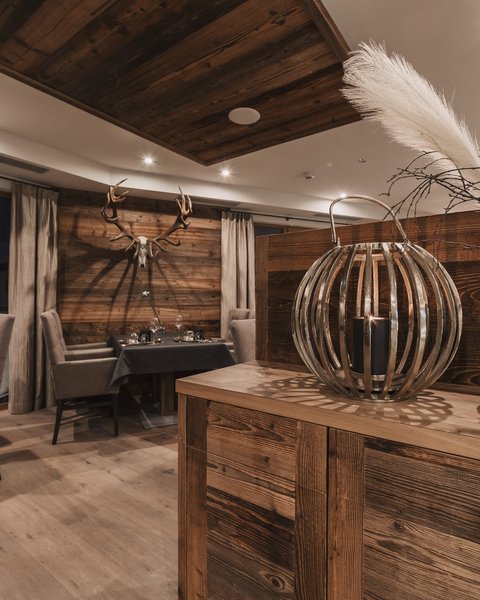 Pictures from Sportalm Rustic restaurant with wooden furniture and deer antlers on the wall