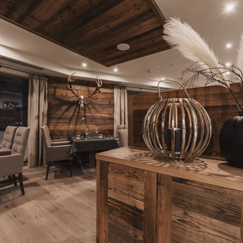 Pictures from Sportalm Rustic restaurant with wooden furniture and deer antlers on the wall