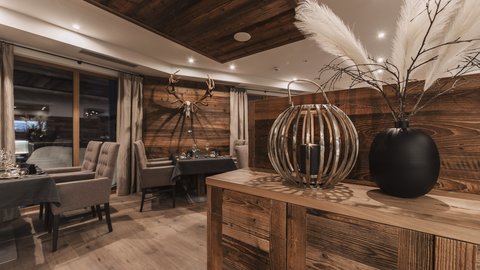 Pictures from Sportalm Rustic restaurant with wooden furniture and deer antlers on the wall
