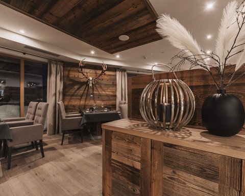 Bilder aus der Sportalm Rustikales Restaurant mit Holzmöbeln und Hirschgeweih an der Wand