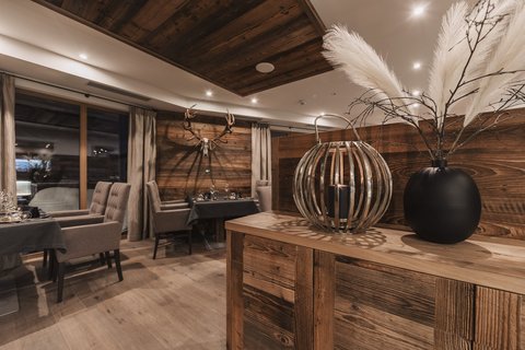 Pictures from Sportalm Rustic restaurant with wooden furniture and deer antlers on the wall