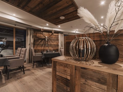 Pictures from Sportalm Rustic restaurant with wooden furniture and deer antlers on the wall