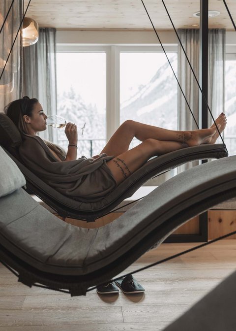 Pictures from Sportalm Woman relaxing on hanging lounge chair in spa with mountain view