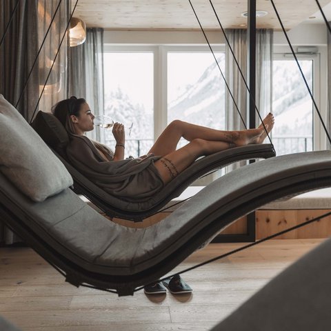 Pictures from Sportalm Woman relaxing on hanging lounge chair in spa with mountain view