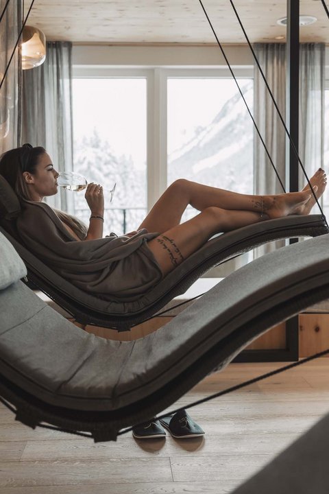 Pictures from Sportalm Woman relaxing on hanging lounge chair in spa with mountain view
