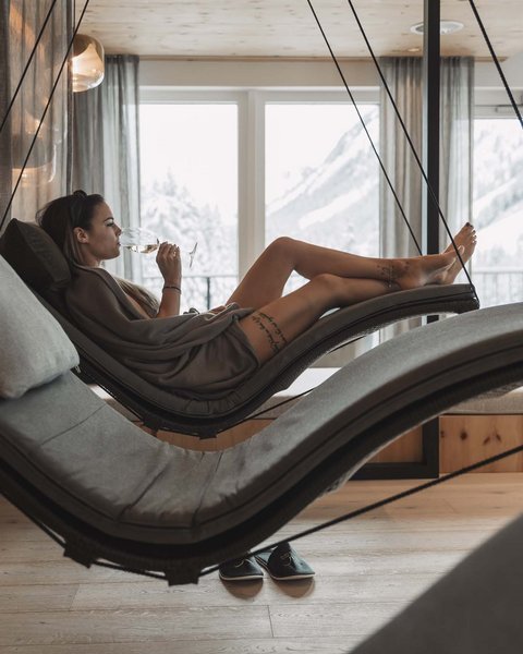 Pictures from Sportalm Woman relaxing on hanging lounge chair in spa with mountain view