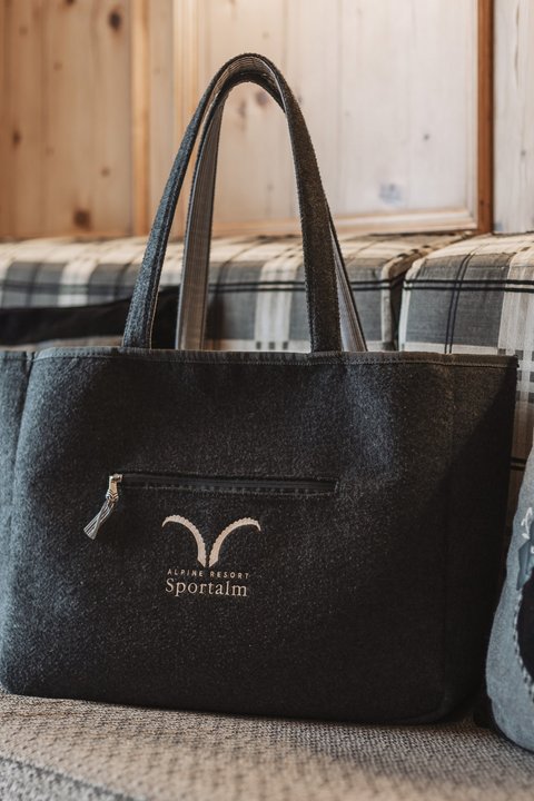 Pictures from Sportalm Felt bag with Alpine Resort Sportalm logo on cozy couch