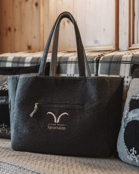 Pictures from Sportalm Felt bag with Alpine Resort Sportalm logo on cozy couch