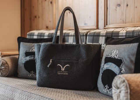 Pictures from Sportalm Felt bag with Alpine Resort Sportalm logo on cozy couch