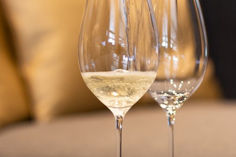 Pictures from Sportalm Wine being poured into wine glass with sofa in background