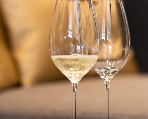 Pictures from Sportalm Wine being poured into wine glass with sofa in background