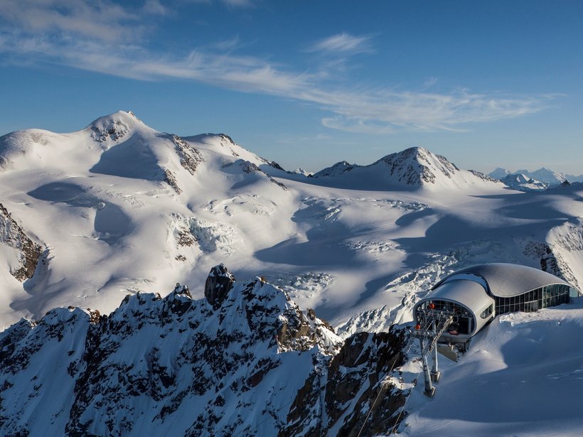 Live from St. Leonhard im Pitztal Snow-covered Alps with ski lift station under clear blue sky
