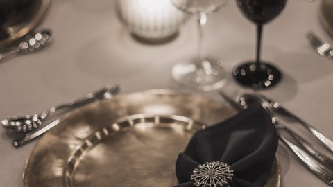 Pictures from Sportalm Elegant table setting with gold plate, black napkin, and candlelight