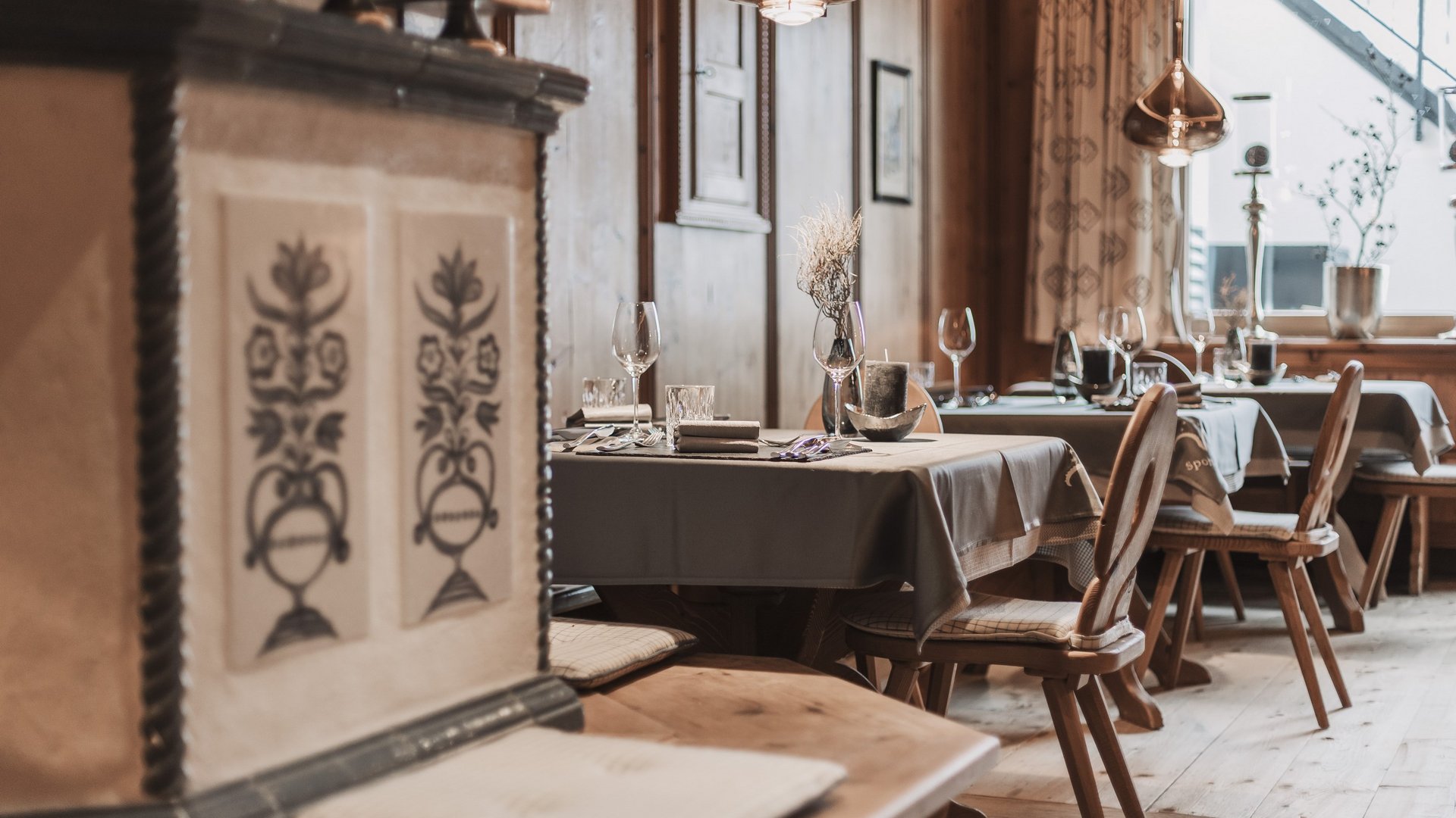 Our restaurant in Pitztal Cozy restaurant interior with set tables and wooden decor