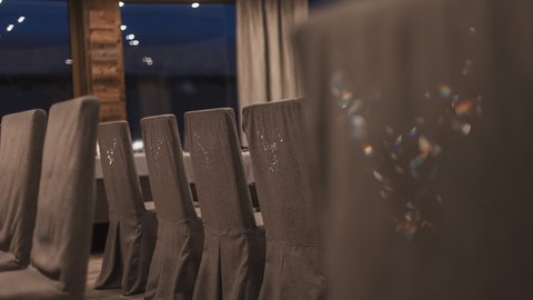 Pictures from Sportalm Row of gray covered chairs in a stylish dining room at night