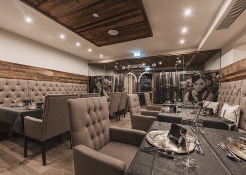 Pictures from Sportalm Elegant restaurant room with comfortable chairs and set dining tables