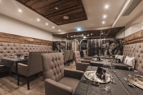 Pictures from Sportalm Elegant restaurant room with comfortable chairs and set dining tables
