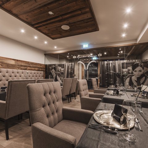 Pictures from Sportalm Elegant restaurant room with comfortable chairs and set dining tables