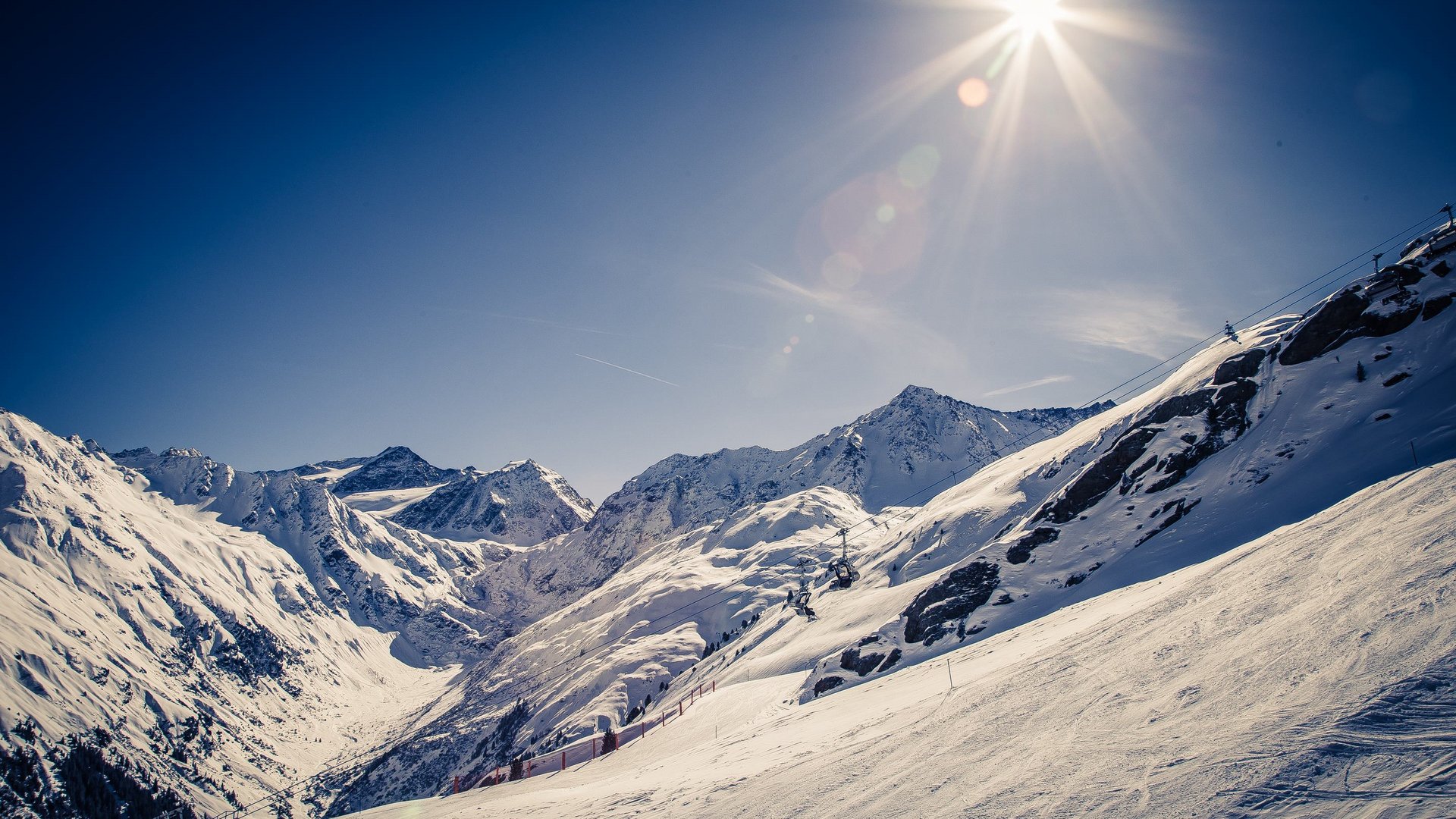Active holidays at our sports hotel in Pitztal Sunny winter day in snowy Alps with ski lift and mountains