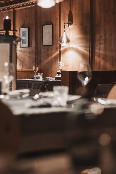 Pictures from Sportalm Cozy restaurant with wooden walls and candlelit set tables