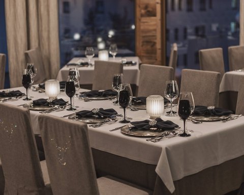 Pictures from Sportalm Elegant restaurant with set tables at dusk