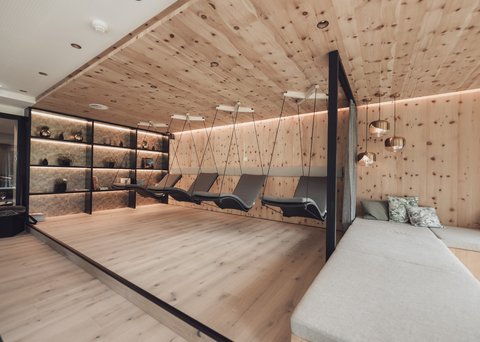 Pictures from Sportalm Modern relaxation room with wooden ceiling, hanging loungers, and comfortable sofas