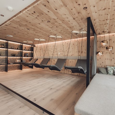 Pictures from Sportalm Modern relaxation room with wooden ceiling, hanging loungers, and comfortable sofas