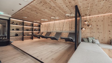 Pictures from Sportalm Modern relaxation room with wooden ceiling, hanging loungers, and comfortable sofas