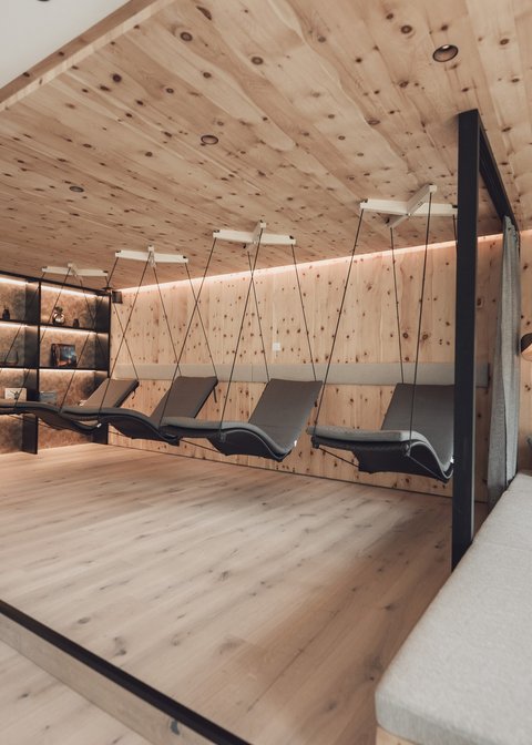 Pictures from Sportalm Modern relaxation room with wooden ceiling, hanging loungers, and comfortable sofas