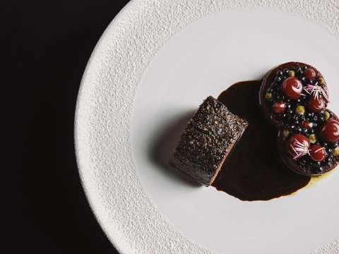 Our restaurant in Pitztal Elegant dish with roasted meat and creative garnish on white plate