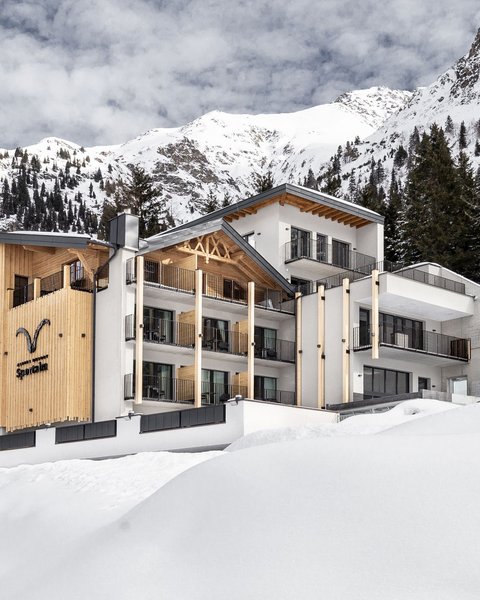 Pictures from Sportalm Modern hotel in snowy mountain landscape with trees and cloudy sky