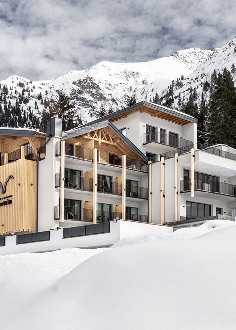 Pictures from Sportalm Modern hotel in snowy mountain landscape with trees and cloudy sky