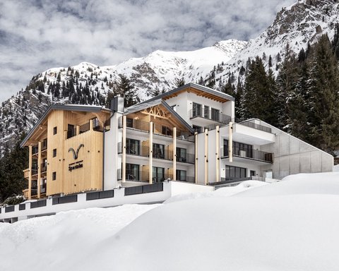 Pictures from Sportalm Modern hotel in snowy mountain landscape with trees and cloudy sky