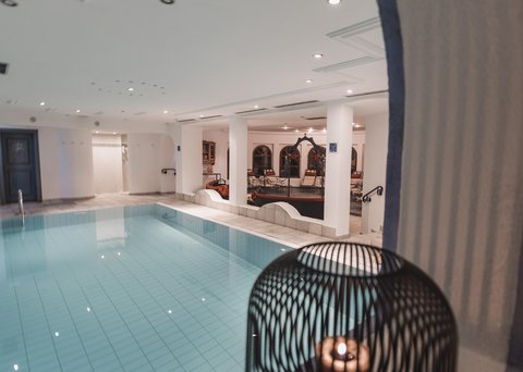 Pictures from Sportalm Indoor area with lit swimming pool and candle in decorative cage